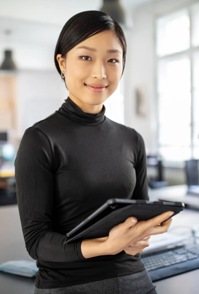 A woman in a black shirt holding a tablet